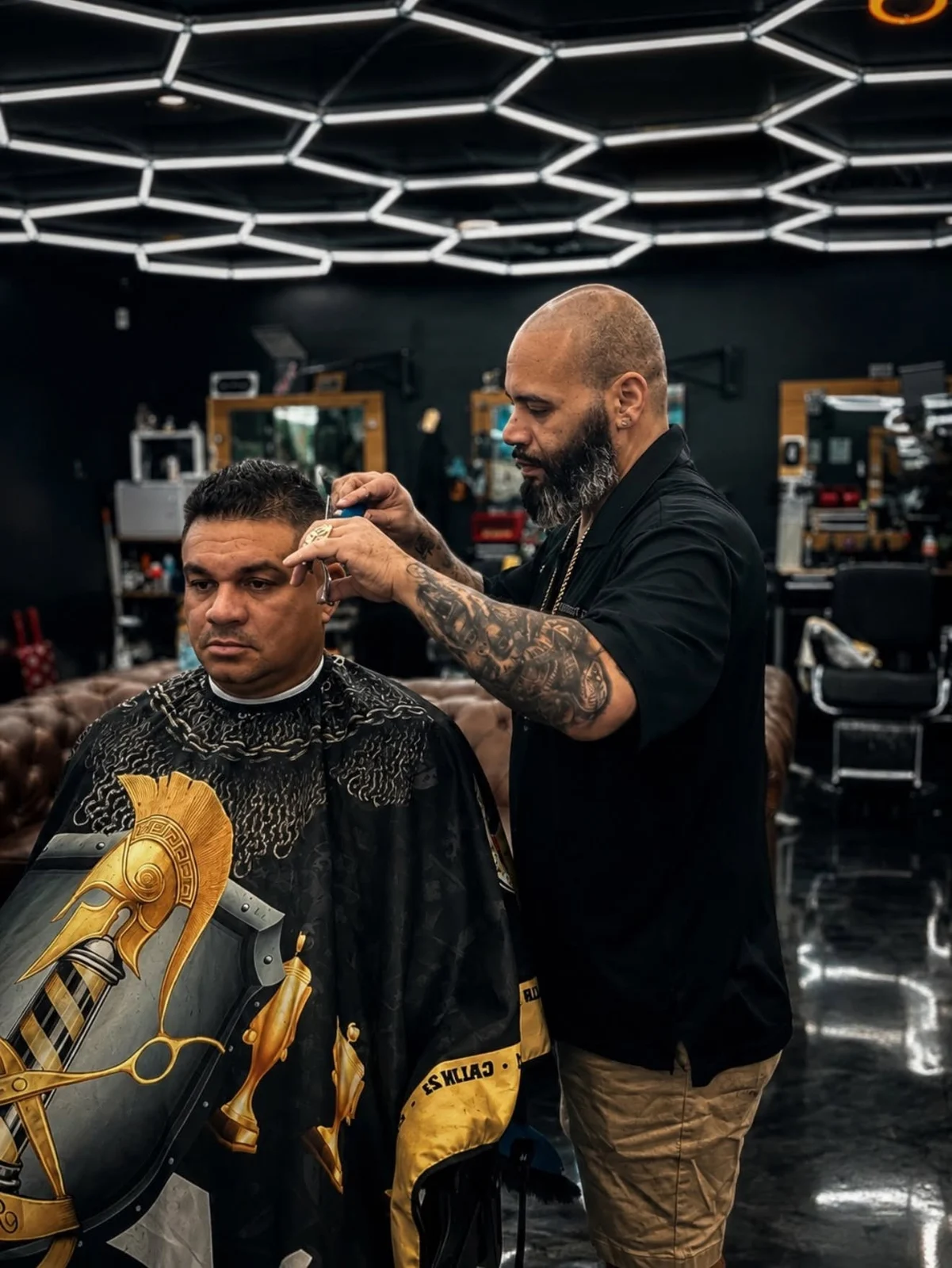 Barber shaping a customer’s haircut at Imperial Barbershop.